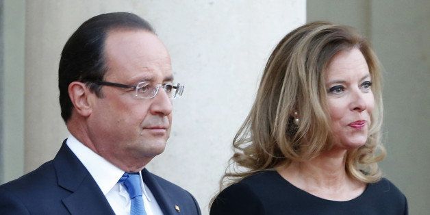 FILE - In this Sept. 3, 2013 file photo, French president Francois Hollande and his companion Valerie Trierweiler wait for German President Joachim Gauckand, at the Elysee Palace, in Paris. Trierweiler' s book "Merci pour ce moment" (Thanks for this moment) relates her life at the presidential palace and will go on sale Thursday. (AP Photo/Jacques Brinon, File)