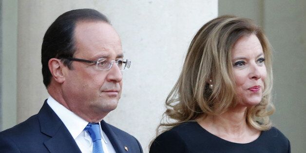 FILE - In this Sept. 3, 2013 file photo, French president Francois Hollande and his companion Valerie Trierweiler wait for German President Joachim Gauckand, at the Elysee Palace, in Paris. Trierweiler' s book "Merci pour ce moment" (Thanks for this moment) relates her life at the presidential palace and will go on sale Thursday. (AP Photo/Jacques Brinon, File)