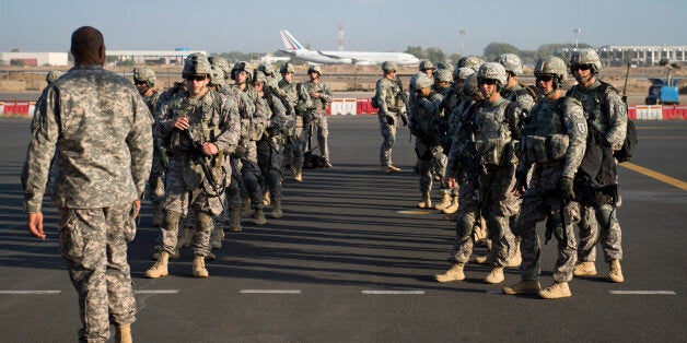 In this photo taken Wednesday, Dec. 18, 2013 and released by the U.S. Air Force, soldiers of the East Africa Response Force (EARF), a Djibouti-based joint team assigned to Combined Joint Task Force-Horn of Africa, prepare to load onto a U.S. Air Force C-130 Hercules at Camp Lemonnier, Djibouti, to support with an ordered departure of personnel from Juba, South Sudan. Gunfire hit three U.S. military CV-22 Osprey aircraft Saturday, Dec. 21, 2013 trying to evacuate American citizens in Bor, the capital of the remote region of Jonglei state in South Sudan, that on Saturday became a battle ground between South Sudan's military and renegade troops, officials said, with four U.S. service members wounded in the attack. (AP Photo/U.S. Air Force, Tech. Sgt. Micah Theurich)