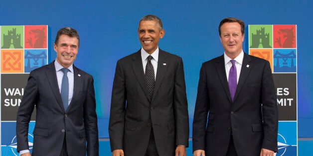 U.S. President Barack Obama, center, stands with NATO Secretary General Anders Fogh Rasmussen, left, and British Prime Minister David Cameron as he arrives for a NATO summit at the Celtic Manor Resort in Newport, Wales on Thursday, Sept. 4, 2014. World leaders gathered at the golf resort in Wales for a high-stakes NATO summit. While the official agenda will focus on the crisis in Ukraine and the drawdown of the NATO combat mission in Afghanistan, the rise of the Islamic State group in Iraq and Syria will dominate discussions on the sidelines of the summit. (AP Photo/Jon Super)