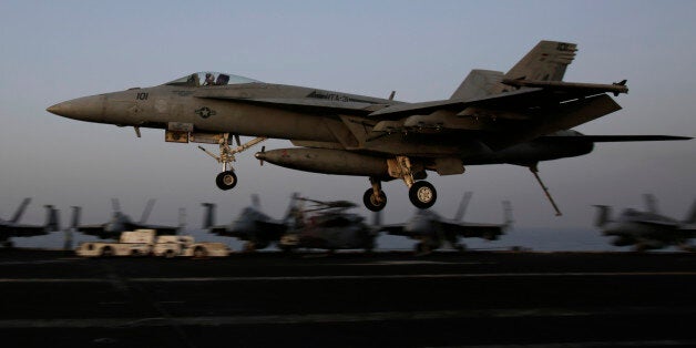 An F/A-18C Hornet coming from Iraq lands on the flight deck of the U.S. Navy aircraft carrier USS George H.W. Bush, Sunday, Aug. 10, 2014 in the Persian Gulf. Aircraft aboard the George H.W. Bush are flying missions over Iraq after U.S. President Barack Obama authorized airstrikes against Islamic militants and food drops for Iraqis trapped by the fighters. (AP Photo/Hasan Jamali)