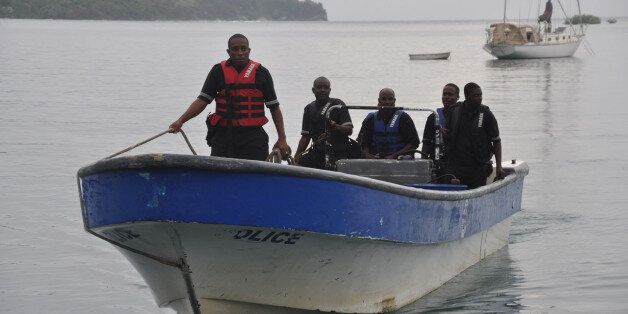Jamaican Marine Police return to the Port Antonio Marina after a fruitless search for a plane that crashed into the ocean near Port Antonio, Jamaica, Friday, Sept. 5, 2014. A small plane flew down the Atlantic Coast and beyond Friday before finally crashing in the waters off Jamaica. The fate of the two or more people aboard was not immediately known. Maj. Basil Jarrett of the Jamaican Defense Force said the plane went down northeast of the coastal town of Port Antonio and the military dispatched two aircraft and a dive team. (AP Photo/Everard Owen)