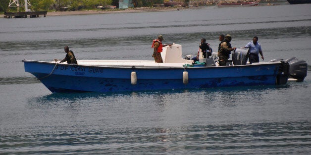 Jamaican Defence Force members return to Port Antonio Marina in Portland, Jamaica, Saturday, Sept. 6, 2014, after a fruitless