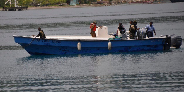 Jamaican Defence Force members return to Port Antonio Marina in Portland, Jamaica, Saturday, Sept. 6, 2014, after a fruitless search for a plane that crashed into the ocean a day earlier. Rescue crews searching off Jamaica's coast on Saturday said they could no longer see debris spotted earlier, stymieing efforts to solve the mystery surrounding a small plane carrying a prominent upstate New York couple that went on a ghostly 1,700-mile journey after the pilot was apparently incapacitated. Jamaican officials said that possible wreckage from the single-engine turboprop Socata TBM700 was sighted Friday evening by a military aircraft flying off the island's northeast coast, drifting roughly 24 miles off the coastal town of Port Antonio. (AP Photo/Everard Owen)