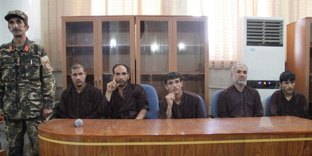 KABUL, AFGHANISTAN - SEPTEMBER 7: Seven men who gang-raped four women on August 23, sit in court in Kabul, Afghanistan on September 7, 2014. Afghanistan handed the death penalty to seven men on Sunday for raping and robbing a group of women returning from a wedding in a rare case of sexual assault that has shaken the capital and raised concerns over public security at a time of transition. (Photo by Haroon Sabawoon/Anadolu Agency/Getty Images)