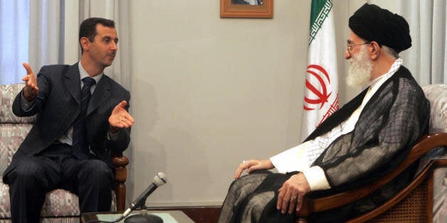 TEHRAN, IRAN: Syrian President Bashar al-Assad (L) meets with Iranian supreme leader Ali Khamenei in Tehran, 08 August 2005. Syrian President Bashar al-Assad, Iran's leading Arab ally, arrived in Tehran for talks with his newly sworn-in counterpart Mahmood Ahmadinejad as the first visit by a foreign leader since Ahmadinejad took the oath of office. Assad is to discuss the situation in neighbouring Iraq, the Palestinian territories, Lebanon and the Shiite militant group Hezbollah, during his two-day visit to Iran. AFP PHOTO/STR (Photo credit should read STR/AFP/Getty Images)