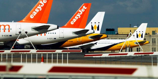 Monarch and easyJet planes stand on the tarmac of Luton Airport after Britain's air traffic service banned all non-emergency flights until at least 7 a.m. (0600 GMT, 2 a.m. EDT) Friday in Luton, England Thursday, April 15, 2010. Airports in Britain, Ireland and Nordic countries have been closed because ash from the volcano that erupted Wednesday makes flying too dangerous as ash clouds high in the atmosphere have the potential to shut down jet engines. (AP Photo/Matt Dunham)