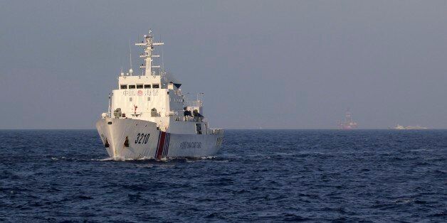 In this Thursday, May 15, 2014 photo, China Coast Guard 3210 vessel sails in the waters claimed by China and Vietnam in the South China Sea. China's deployment of an oil rig off Vietnam's coast has prompted a tense sea standoff and touched off deadly anti-China rioting. The conflict pits two neighbors with very similar governments but whose people bear ill feelings rooted in a rivalry that dates back centuries and has occasionally burst out into armed conflict. (AP Photo/Hau Dinh)