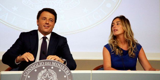 Italian Premier Matteo Renzi, left, flanked by Reforms Minister Maria Elena Boschi, addresses a media conference to announce the government's agenda for the next 1000 days, at Rome's Chigi palace, Monday, Sept. 1, 2014. Renzi set his government a deadline of a 1000 days in which to change the country, where the results can be followed daily on a website launched specifically for the 1000-day agenda. (AP Photo/Gregorio Borgia)