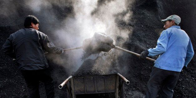 Chinese workers load coals to a cart in Miyun, north of Beijing, China, Monday, Jan. 21, 2008. China Coal Energy Co., the country's second-largest coal miner, plans to begin trading its shares on the Shanghai Stock Exchange on Feb. 1 following an initial public offering expected to raise at least US$4.4 billion. (AP Photo/Andy Wong)