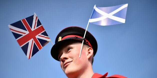 A member of the Grand Orange Lodge of Scotland prepares ahead of a march in Edinburgh, on September 13, 2014. Thousands of m