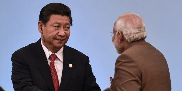 Chinese President Xi Jinping (L) shakes hands with Indian Prime Minister Narendra Modi during the 6th BRICS Summit in Fortaleza, Brazil, on July 15, 2014. Leaders of the BRICS (Brazil, Russia, India, China and South Africa) group of emerging powers gathered in Brazil on Tuesday to launch a new development bank and a reserve fund seen as counterweights to Western-led financial institutions. AFP PHOTO/YASUYOSHI CHIBA (Photo credit should read YASUYOSHI CHIBA/AFP/Getty Images)