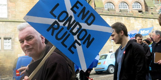 FILE - In this March 15, 2014 file photo, a demonstrator carries a sign during a pro-independence march in Edinburgh, Scotland. A Sept. 18, 2014 referendum will determine if Scotland becomes independent of the United Kingdom. (AP Photo/Jill Lawless)