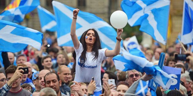 GLASGOW, SCOTLAND - SEPTEMBER 17: A young women joins Yes activists as they gather in George Square on September 17, 2014 in Glasgow,Scotland.The referendum debate has entered its final day of campaigning as the Scottish people prepare to go to the polls tomorrow to decide whether or not Scotland should have independence and break away from the United Kingdom. (Photo by Jeff J Mitchell/Getty Images)