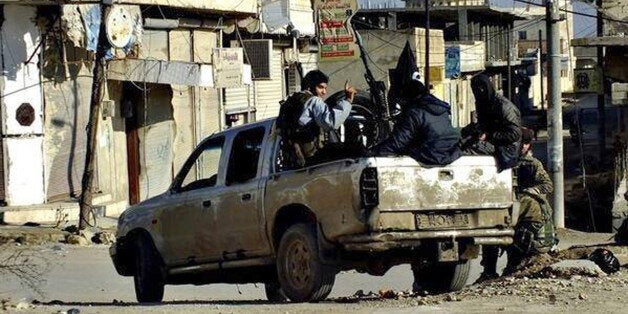 FILE - This undated file image posted on a militant website on Tuesday, Jan. 14, 2014 shows fighters from the al-Qaida linked