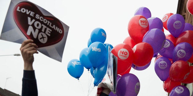 Balloons held by Yes supporters float next to balloons and posters held by No supporters after a No campaign event where a number of speeches were made by different people and politicians in Glasgow, Scotland, Wednesday, Sept. 17, 2014. Will the ayes have it, or will Scotland say naw thanks? No one is certain. Excitement and anxiety mounted across the country Wednesday, the final day of campaigning before Thursday's referendum on independence. With opinion polls suggesting the result is too close to call and turnout expected to reach record levels, supporters of separation feel they are within touching distance of victory â but wonder whether their surge in the polls will be enough. (AP Photo/Matt Dunham)