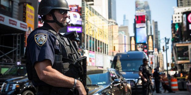 NEW YORK, NY - SEPTEMBER 17: New York City police officers stand guard in Times Square on September 17, 2014 in New York City. A blog affiliated with the Islamic State in Iraq and Syria (ISIS) mentioned Times Square as a target for bombing. (Photo by Andrew Burton/Getty Images)