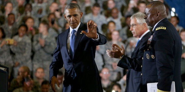 TAMPA, FL - SEPTEMBER 17: U.S. President Barack Obama waves as he arrives on stage to speak during a visit to the U.S. Central Command at the MacDill Air Force Base on September 17, 2014 in Tampa, Florida. On stage with him are Defense Secretary Chuck Hagel (L) and General Lloyd Austin, commander of U.S. Central Command. Obama visited the base to receive a briefing from his top commanders at CENTCOM, on the strategy to degrade and destroy ISIL. (Photo by Joe Raedle/Getty Images)