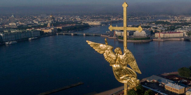 In this aerial photo the city landmark, a gilded weather vane in the form of an angel, fixed atop a spire of the Saints Peter and Paul Cathedral at the altitude of 122 meters shows the direction of the North-West wind in St Petersburg, Russia, Thursday, June 12, 2014, with the Neva River in the background. (AP Photo/Dmitry Lovetsky)