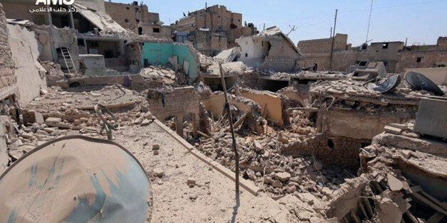 In this photo provided by the anti-government activist group Aleppo Media Center (AMC), which has been authenticated based on its contents and other AP reporting, buildings are seen destroyed in an airstrike by the Syrian government in Aleppo, Syria, Friday, Aug. 29, 2014. (AP Photo/Aleppo Media Center AMC)