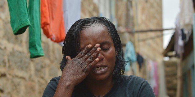 TO GO WITH AFP STORY BY REUBEN KYAMAEunice Khavetsa, 27, widow of Kenyan security guard Maurice Adembesa, weeps at her home in one of Nairobi's crowded suburbs as she recounts seeing her late husband's body following the massacre of 67 people at the upmarket Wesgate mall a year ago on September 21. 'Our lives have changed forever,' said Ombisa's widow Eunice Khavetsa, who now cares for her nine-year old son and seven-year old daughter alone. AFP PHOTO/Tony KARUMBA (Photo credit should read TONY KARUMBA/AFP/Getty Images)