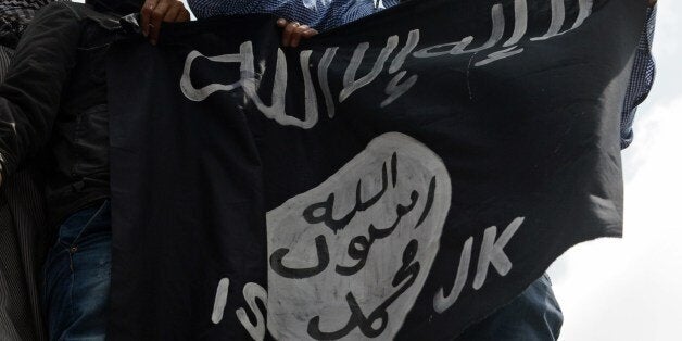 Kashmiri demonstrators hold up a flag of the Islamic State of Iraq and the Levant (ISIL) during a demonstration against Israe