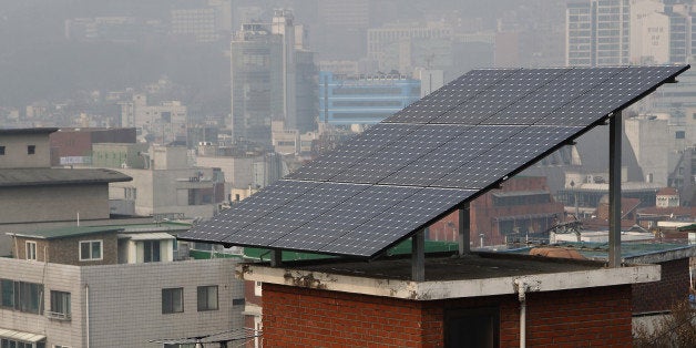 Solar panels sit on the rooftop of a residential building in the Ewha-dong area of Seoul, South Korea, on Friday, Jan. 17, 2014. South Korean Finance Minister Hyun Oh Seok told reporters on Jan. 15 that the housing market is 'a bit' better than last year and its recovery is important to economic growth. Photographer: SeongJoon Cho/Bloomberg via Getty Images