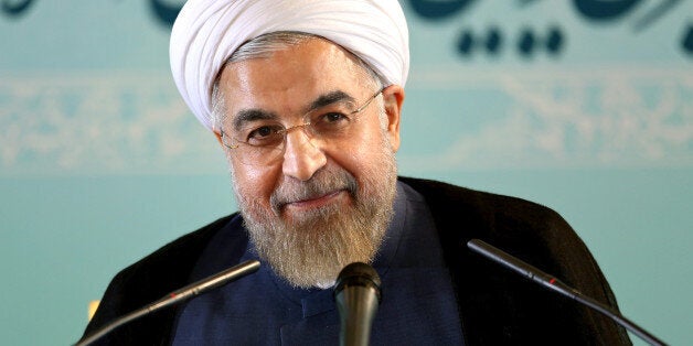 Iranian President Hassan Rouhani gives a press conference in Tehran, Iran, Saturday, Aug. 30, 2014. Rouhani called Western sanctions an "invasion" on Saturday after Washington imposed existing sanctions on more than 25 businesses, banks and individuals suspected of working to expand Iran's nuclear program, support terrorism and help Iran evade U.S. and international sanctions. Iran's state TV also said the move violated an interim agreement reached with world powers under which Western nations agreed to ease sanctions in exchange for Iran curbing its nuclear activities. However, Friday's action did not constitute an expansion of the sanctions regime. (AP Photo/Ebrahim Noroozi)