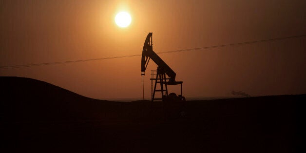 FILE - In this March 2, 2013 file photo, a view of an oil field under control of Kurdish militias near the town of Deriq, in a Kurdish area of Syria, near the border with Iraq. The Islamic State militants, who once relied on wealthy Persian Gulf nations for money, have become a self-sustaining financial juggernaut, earning more than $3 million a day from oil smuggling, human trafficking, theft and extortion, according to U.S. intelligence officials and private experts. The group, which has taken over large sections of Syria and Iraq, controls as many as 11 oil fields in both countries, analysts say. It is selling oil and other goods through generations-old smuggling networks under the noses of some of the same governments it is fighting: Kurdish-controlled northern Iraq, Turkey and Jordan. (AP Photo/Manu Brabo, File)