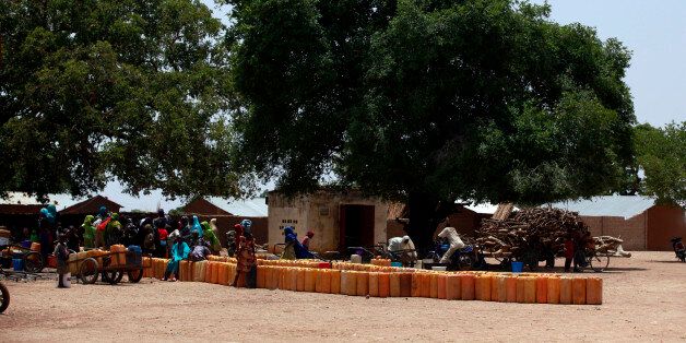 In this photo taken Monday, May 19, 2014, people gather to fetch water at a public well, in Chibok, Nigeria. More than 200 schoolgirls were kidnapped from a school in Chibok in Nigeria's north-eastern state of Borno on April 14. Boko Haram claimed responsibility for the act. (AP Photo/Sunday Alamba)