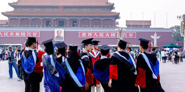 BEIJING, CHINA - 2014/06/19: Graduates from Peking Union Medical College take commemorative photos in Tienanmen Square. In 2014, 7.27 million students will graduate from China's universities, the highest number so far, which is putting growing pressure on young Chinese job-seekers at a time of slowing economic growth. Recent unemployment figures for graduates were recorded at 16 percent, while entry-level graduate salaries continue their downward slide. (Photo by Zhang Peng/LightRocket via Getty Images)