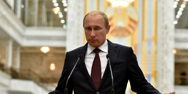 Russia's President Vladimir Putin gives a press conference after a summit in Minsk early on August 27, 2014. Putin and Porosh