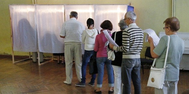 People wait on September 14, 2014 before voting at a polling station in Simferopol during combined regional and local electio