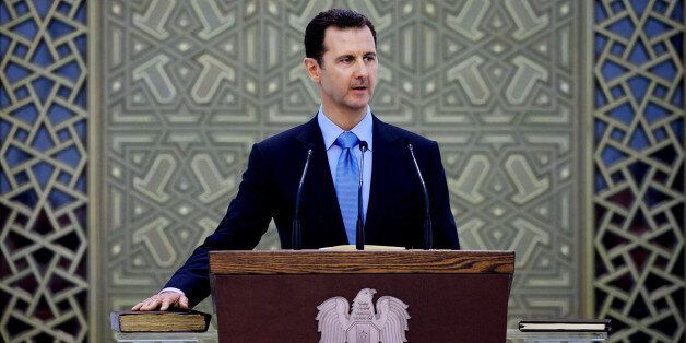 In this Wednesday July 16, 2014 photo, and released by the Syrian official news agency SANA, Syria's President Bashar Assad is sworn for his third, seven-year term, in Damascus, Syria. Proclaiming the Syrian people winners in a "dirty war" waged by outsiders, Assad was sworn in on Wednesday, marking the start of his third seven-year term in office amid a bloody civil war that has ravaged the Arab country. (AP Photo/SANA)