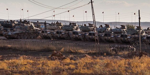 SANLIURFA, TURKEY - SEPTEMBER 28: Turkish tanks are shown lined up in a closed area behind the border with Syria in Suruc September 28, 2014 south of Sanliurfa, Turkey. Islamic State (IS, also called ISIS and ISIL) fighters are reportedly advancing with heavy weaponry on the strategic Kurdish border town of Kobani (also called Ayn Al-Arab), which they have surrounded on three sides. Several hundred thousand refugees are reportedly in Kobani and aid agencies are bracing for a massive exodus into Turkey. (Photo by Carsten Koall/Getty Images)
