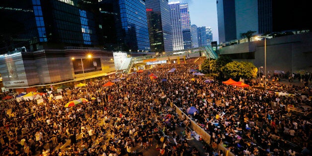 Thousands of pro-democracy activists gather on the streets, Wednesday, Oct. 1, 2014 in Hong Kong. Holiday crowds swelled into the tens of thousands as student leaders met with other pro-democracy protesters Wednesday to thrash out a strategy for handling the government's rejection of their demands that the city's top leader resign and Beijing revise its plans to limit political reforms. (AP Photo/Wong Maye-E)