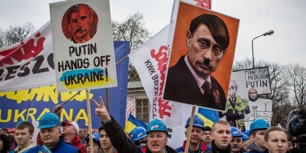 Members of Polish trade union 'Solidarity' demonstrate with placards reading 'Putin, hands off Ukraine!' for a democratic and