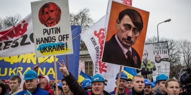 Members of Polish trade union 'Solidarity' demonstrate with placards reading 'Putin, hands off Ukraine!' for a democratic and independent Ukraine and against a Russian military intervention on March 8, 2014 in front of the Russian embassy in Warsaw. AFP PHOTO / WOJTEK RADWANSKI (Photo credit should read WOJTEK RADWANSKI/AFP/Getty Images)