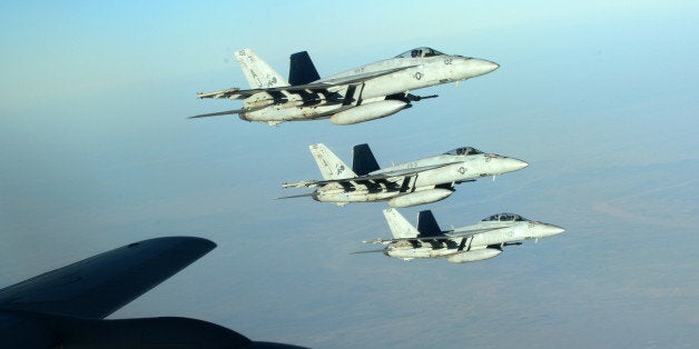 In this Tuesday, Sept. 23, 2014 photo released by the U.S. Air Force, a formation of U.S. Navy F-18E Super Hornets leaves aft