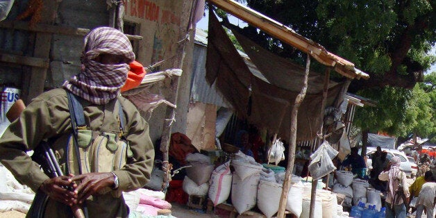 An armed Al-Shabaab fighter patrols Bakara Market in Mogadishu, Somalia, Monday, June 29, 2009. Somali radical Islamic insurgent says weapons and ammunition the United States recently supplied to Somalia's embattled government will only increase violence in the war-wracked country. Sheik Hassan Ya'qub, a spokesman for the militant group al-Shabab in the port town of Kismayo, was responding to an announcement by U.S. officials last week that the Obama administration had supplied arms and provided military training worth just under $10 million to the shaky official government. (AP Photo/Farah Abdi Warsameh))