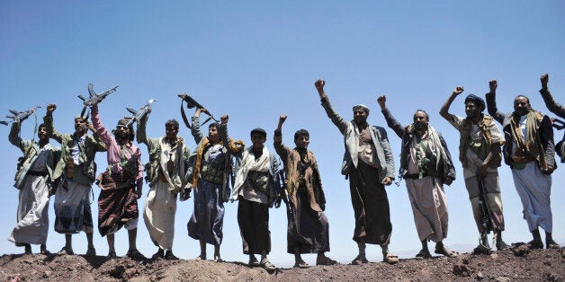 Hawthi Shiite rebels chant slogans at the compound of the army's First Armored Division, after they took it over, in Sanaa, Yemen, Monday, Sept. 22, 2014. Heavily armed Yemeni Shiite militiamen took over the headquarters and house of a powerful army general allied to Sunni Islamists on Monday and set up checkpoints across the capital, Sanaa, after sweeping across the city as the general and his allies fled and went into hiding. (AP Photo/Hani Mohammed)