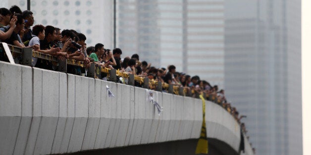 Demonstrators on an elevated road look at the office of Hong Kong's chief executive Leung Chun-ying in Hong Kong, China, on Thursday, Oct. 2, 2014. Hong Kong police said they would not tolerate attempts by pro-democracy protesters to surround or invade public buildings, as Leung faced calls to open a dialogue with students who are seeking his resignation. Photographer: Tomohiro Ohsumi/Bloomberg via Getty Images