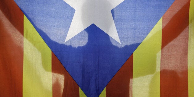 BARCELONA, SPAIN - OCTOBER 2: A protestor holds a 'Estelada' the Catalan independentist flag as 'Students for 9N', a platform of several students organizations protest to demand of the Catalans right to vote in defense of Independence Referendum next 9th of November, in Barcelona, Spain on October 2, 2014. After the Catalan Independence Referendum being suspended by Spain's Top Court, demonstrations are being held in Barcelona daily. Pro-independence Catalans want to vote their future in referendum next 9th of November. (Photo by Joan Alvado/Anadolu Agency/Getty Images)