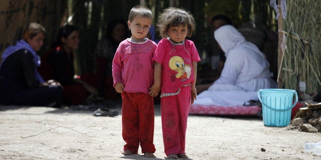 DOHUK, IRAQ - AUGUST 25: Yezidis live difficult conditions in tents, in Zakho district, a few kilometers from the Iraqi-Turkish border, Dohuk on August 25, 2014. Yezidis fled their home due to the assaults of army groups led by Islamic State (IS), formerly known as ISIL, take shelter banks of river to supply water in Zakho. Some of them escape to their holy Sheiks's tombs for taking shelter. Islamic State fighters captured Iraq's Sinjar and Rabia in the Nineveh province after fierce clashes, forcing thousands of Iraqis including Turkmen, Arabs and Yezidis to flee. (Photo by Ensar Ozdemir/Anadolu Agency/Getty Images)