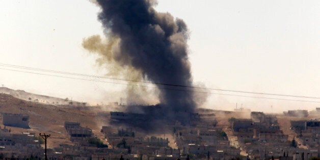 Smoke rises after a shell lands in Kobani in Syria as fighting intensifies between Syrian Kurds and the militants of Islamic State group, as seen from the outskirts of Suruc, at the Turkey-Syria border, Monday, Oct. 6, 2014. Kobani, also known as Ayn Arab and its surrounding areas have been under attack since mid-September, with militants capturing dozens of nearby Kurdish villages. (AP Photo/Lefteris Pitarakis)