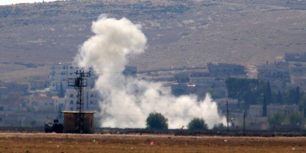 Smoke rises after a shell lands in Kobani in Syria as fighting intensifies between Syrian Kurds and the militants of Islamic State group, as seen from the outskirts of Suruc, at the Turkey-Syria border, Monday, Oct. 6, 2014. Kobani, also known as Ayn Arab and its surrounding areas have been under attack since mid-September, with militants capturing dozens of nearby Kurdish villages. (AP Photo/Lefteris Pitarakis)