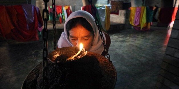 An Iraqi Yazidi visits Lalish temple during the'Feast of the Assembly' on October 6, 2014 in the mountain village of Lalish n