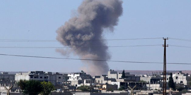 Smoke rises after an airstrike in Kobani, Syria as fighting intensified between Syrian Kurds and the militants of Islamic State group, as seen from Mursitpinar in the outskirts of Suruc, at the Turkey-Syria border, Tuesday, Oct. 7, 2014. Kobani, also known as Ayn Arab and its surrounding areas have been under attack since mid-September, with militants capturing dozens of nearby Kurdish villages.(AP Photo/Lefteris Pitarakis)
