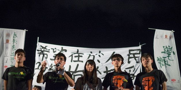 HONG KONG - AUGUST 31: Hong Kong Federation of Students and Scholarism members speak during the protest at Tamar Park outside of the Hong Kong Government Building on August 31, 2014 in Hong Kong, China. The National People's Congress Standing Committee announced the framework for the 2017 chief executive election. (Photo by Anthony Kwan/Getty Images)