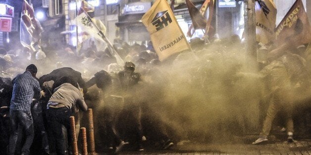 Police used tear gas and water cannon on October 7, 2014 in Istanbul against demonstrators who protest against attacks launched by Islamic State insurgents targeting the Syrian city of Kobane and lack of action by the government. Fresh air strikes by the US-led coalition hit positions held by Islamic State jihadists in the southwest of the key Syrian border town of Ain al-Arab (Kobane), according to an AFP journalist just across the border in Turkey. The strikes came a day after the extremists pushed into Kobane, seizing three districts in the city's east after fierce street battles with its Kurdish defenders. AFP PHOTO/OZAN KOSE (Photo credit should read OZAN KOSE/AFP/Getty Images)